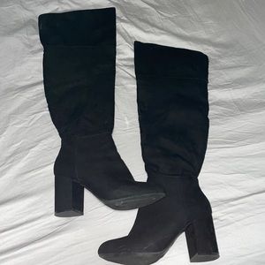 Thigh high black boots.